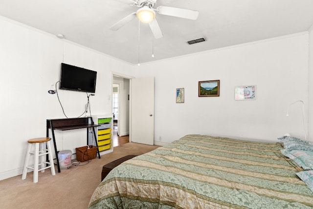 bedroom with ceiling fan, carpet floors, and ornamental molding