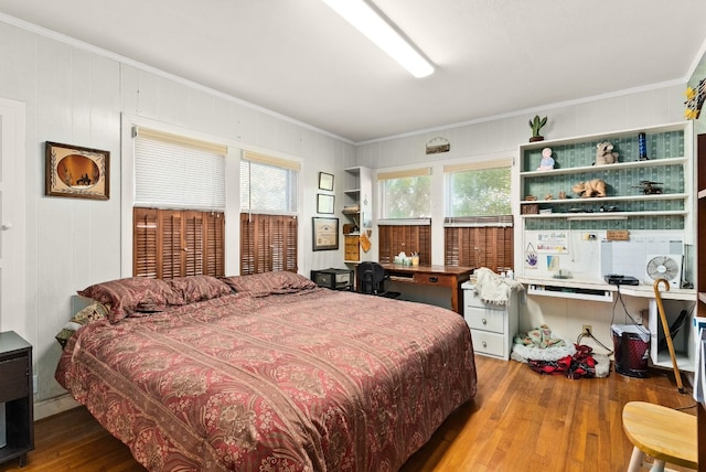 bedroom with crown molding and hardwood / wood-style flooring