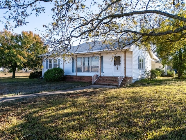 ranch-style home featuring a front yard