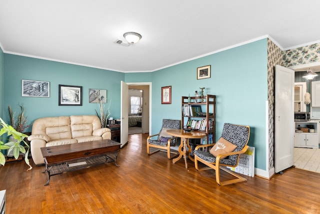 living room with wood-type flooring and crown molding