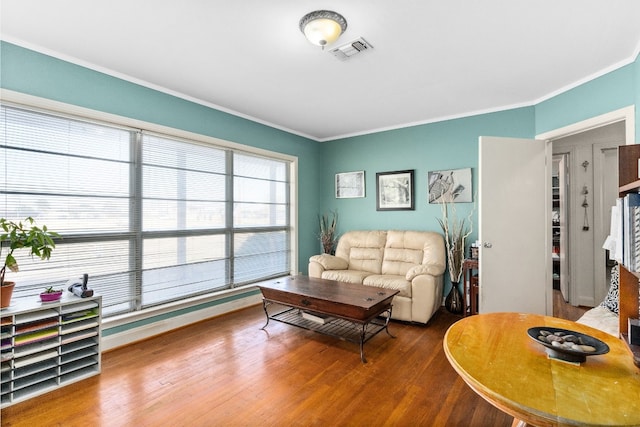 living room featuring wood-type flooring and ornamental molding