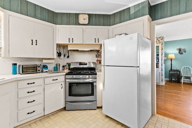 kitchen with white cabinetry, light hardwood / wood-style flooring, stainless steel gas range, and white refrigerator