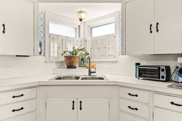 kitchen with white cabinetry and sink