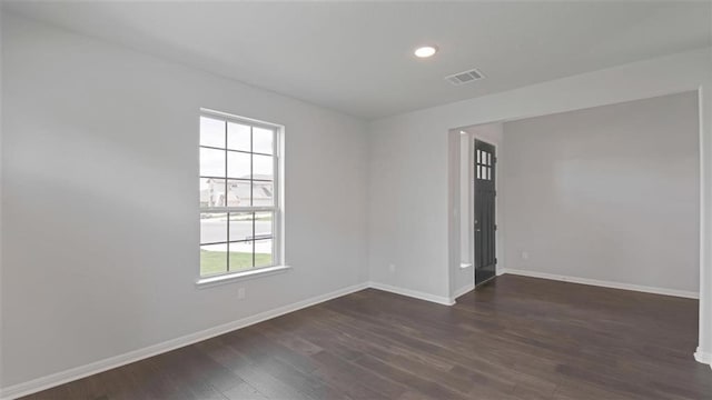 empty room featuring dark hardwood / wood-style floors and a wealth of natural light