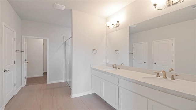 bathroom featuring vanity and an enclosed shower