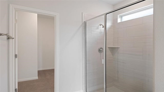 bathroom with a shower with shower door