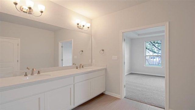 bathroom with vanity and a chandelier