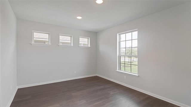 spare room featuring dark wood-type flooring