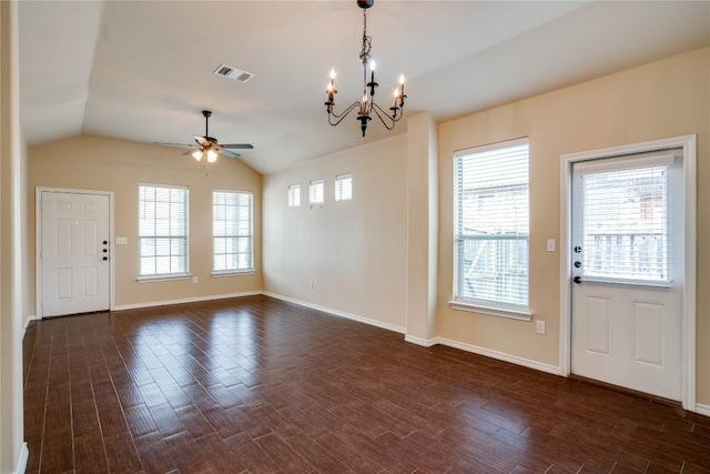 foyer entrance featuring dark hardwood / wood-style floors, ceiling fan with notable chandelier, a wealth of natural light, and vaulted ceiling