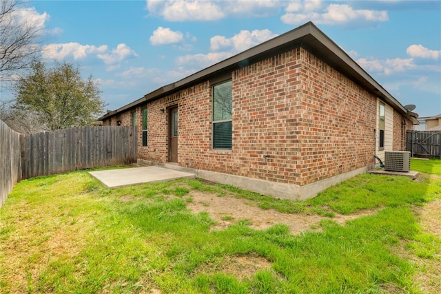 view of property exterior with central air condition unit, a patio area, and a lawn