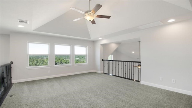 carpeted empty room with ceiling fan and lofted ceiling