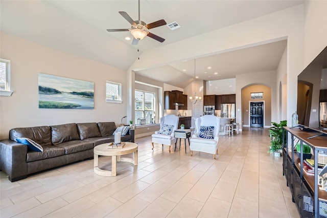 tiled living room featuring high vaulted ceiling and ceiling fan