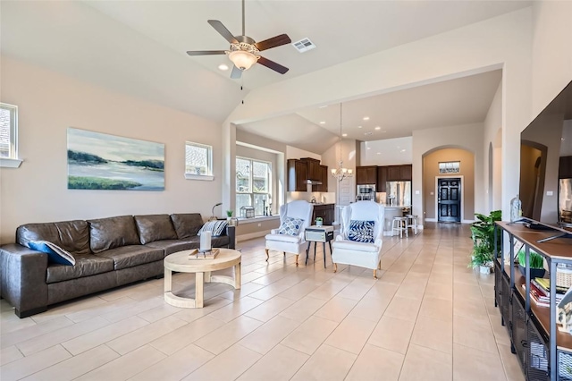 3317 Nighthawk Dive Ln, Pflugerville, TX 78660 - living area featuring arched walkways, ceiling fan, lofted ceiling, a chandelier, and baseboards