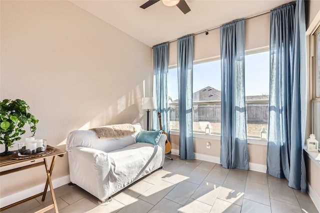 sitting room with ceiling fan, a healthy amount of sunlight, and light tile patterned floors