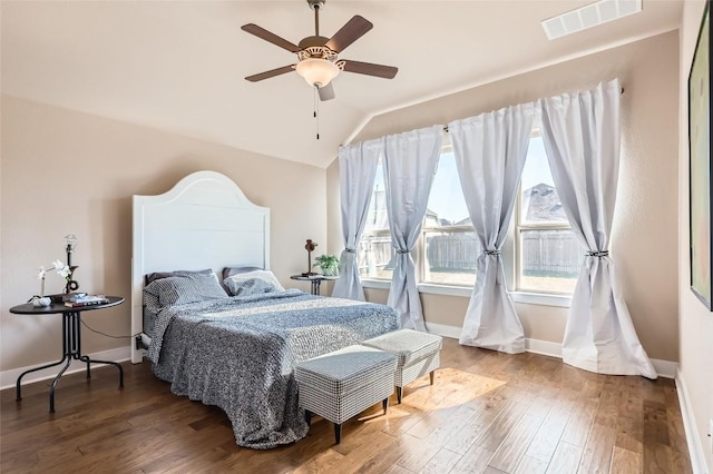 3317 Nighthawk Dive Ln, Pflugerville, TX 78660 - bedroom with vaulted ceiling, multiple windows, wood finished floors, baseboards, and ceiling fan