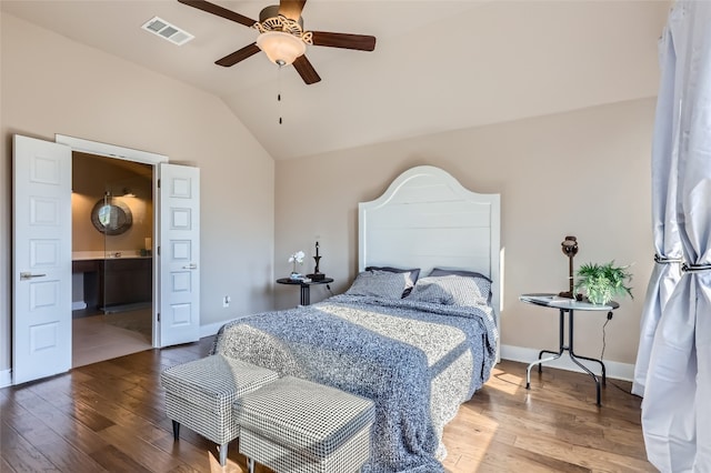 bedroom with ceiling fan, wood-type flooring, lofted ceiling, and connected bathroom