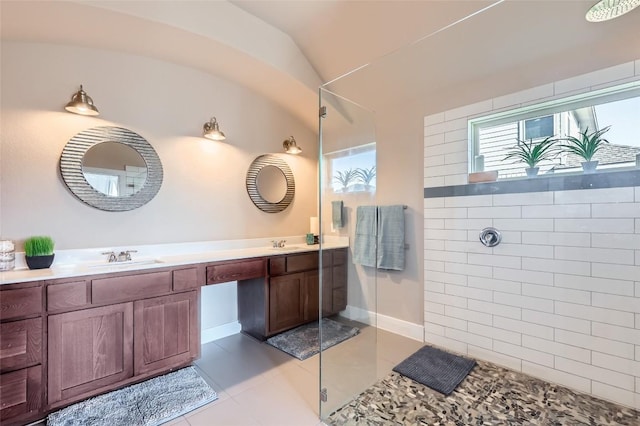 3317 Nighthawk Dive Ln, Pflugerville, TX 78660 - full bathroom with a walk in shower, double vanity, tile patterned floors, lofted ceiling, and baseboards