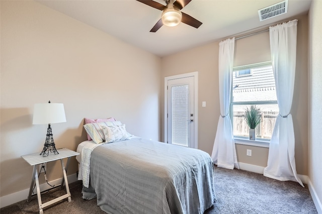 bedroom with ceiling fan and dark carpet