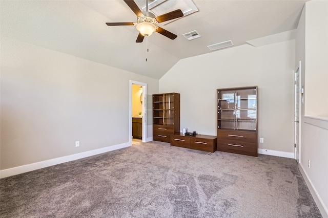 unfurnished bedroom with light colored carpet, ensuite bath, ceiling fan, and lofted ceiling