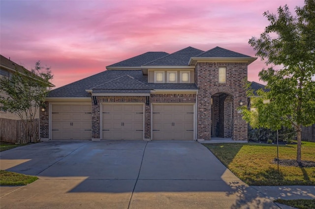 3317 Nighthawk Dive Ln, Pflugerville, TX 78660 - view of front of house with concrete driveway, an attached garage, brick siding, and roof with shingles