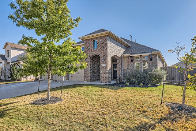 view of front of home featuring a front lawn and a garage