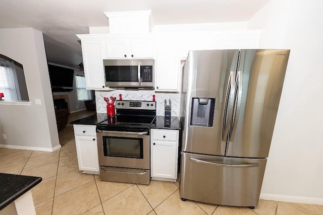 kitchen with white cabinetry, backsplash, light tile patterned floors, and appliances with stainless steel finishes