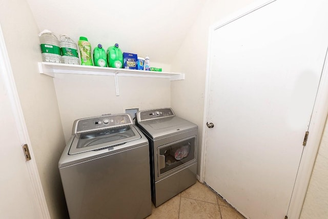 washroom with washing machine and clothes dryer and light tile patterned floors