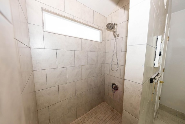 bathroom with tiled shower