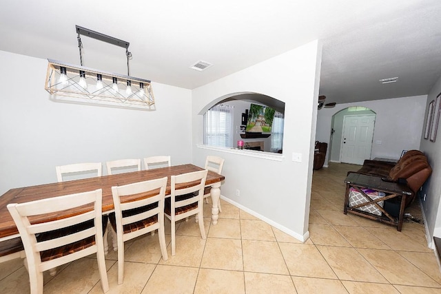 tiled dining room featuring ceiling fan