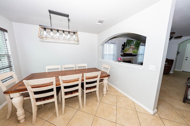 tiled dining area with ceiling fan