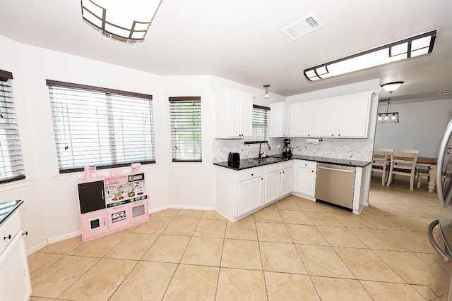 kitchen featuring white cabinetry, light tile patterned floors, tasteful backsplash, and appliances with stainless steel finishes