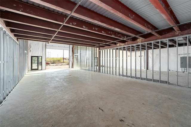 misc room featuring concrete flooring and electric panel