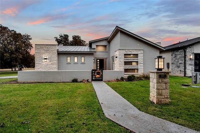 contemporary home with a lawn