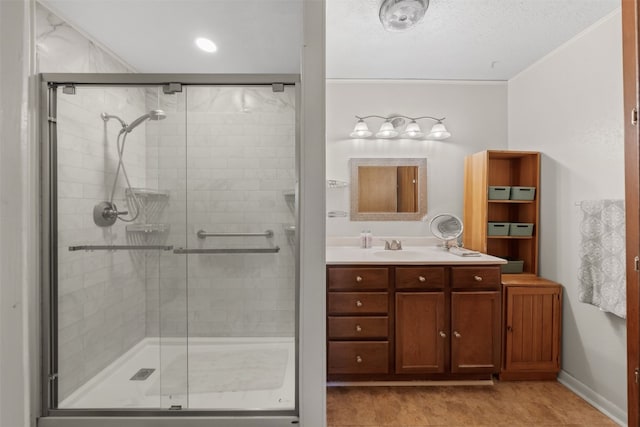 bathroom with tile patterned flooring, vanity, crown molding, and a shower with shower door