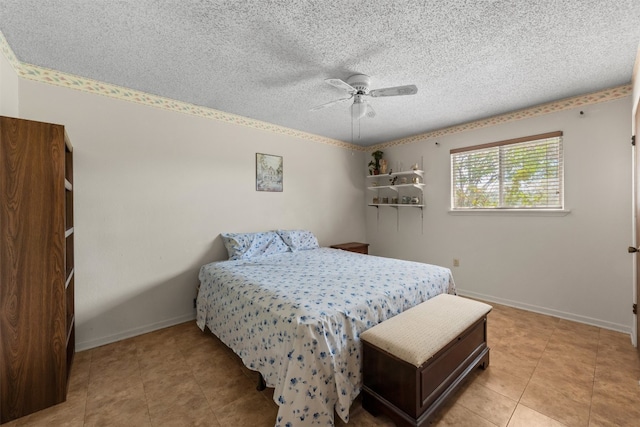 bedroom with ceiling fan and a textured ceiling