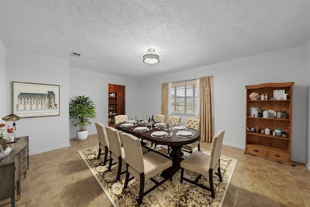 dining space featuring a textured ceiling