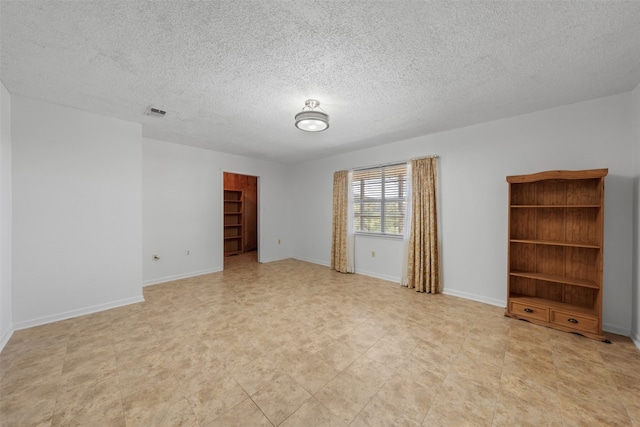 empty room featuring a textured ceiling