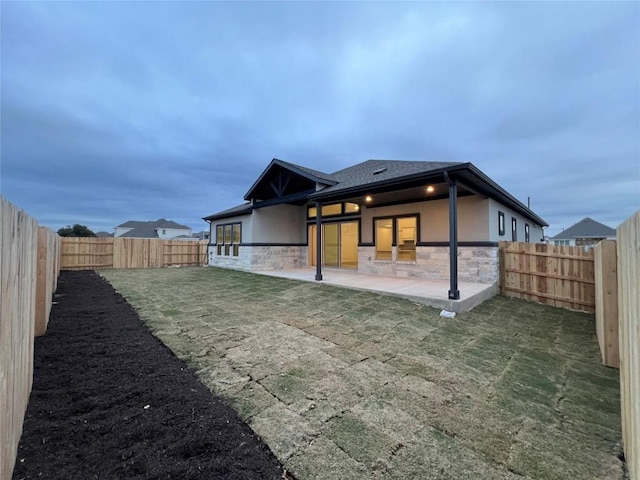 back of house featuring a yard and a patio area