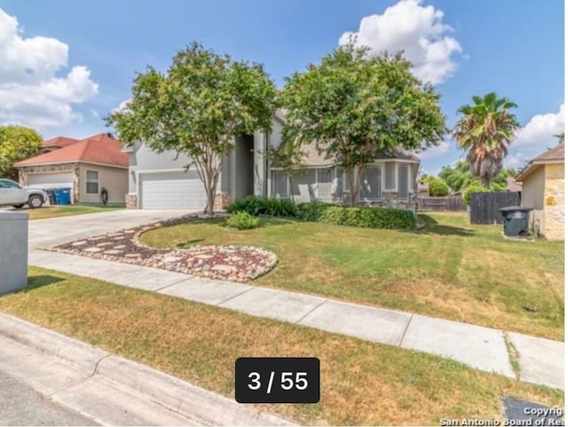 view of front of home with a front yard and a garage