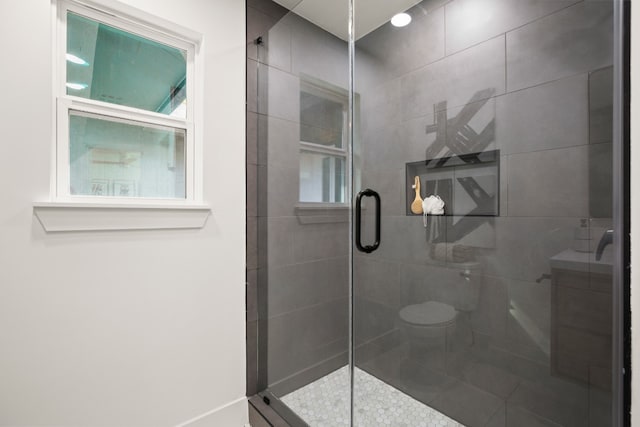 bathroom with an enclosed shower and toilet