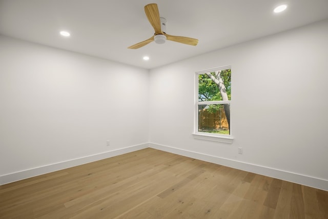 empty room with hardwood / wood-style floors and ceiling fan