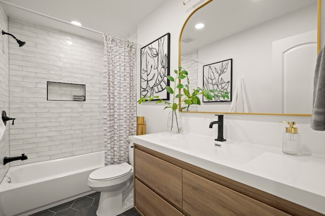 full bathroom with tile patterned floors, shower / bath combo with shower curtain, vanity, and toilet