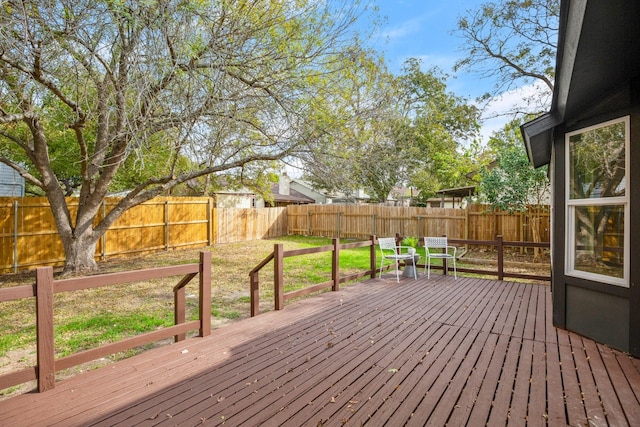 wooden deck featuring a lawn