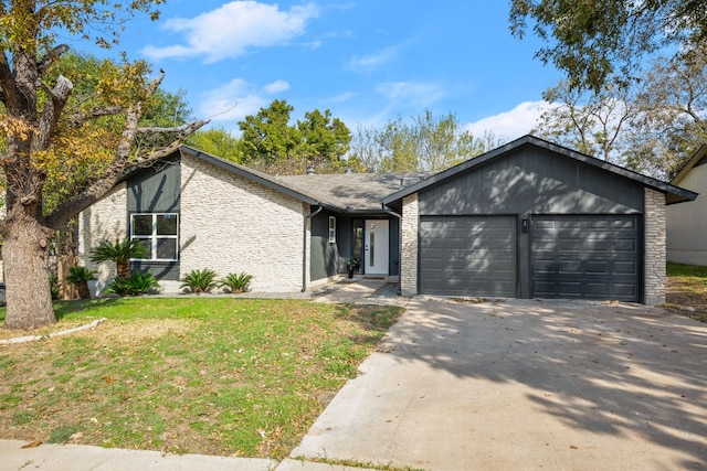 view of front of property with a garage and a front lawn