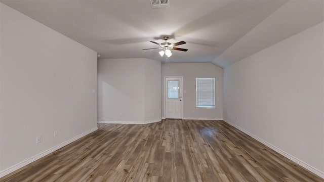 empty room with hardwood / wood-style flooring, ceiling fan, and lofted ceiling