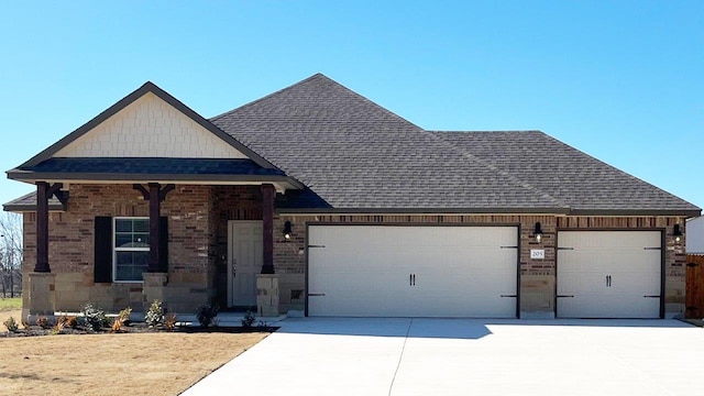 view of front of property featuring a garage, brick siding, a shingled roof, and concrete driveway