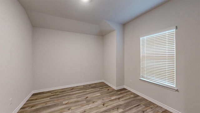 spare room with light wood-style floors and baseboards