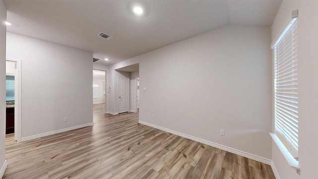 unfurnished room with light wood-type flooring, baseboards, and visible vents