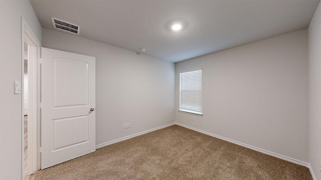 unfurnished room with visible vents, carpet flooring, and baseboards