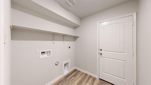 clothes washing area featuring light wood finished floors, baseboards, washer hookup, electric dryer hookup, and laundry area